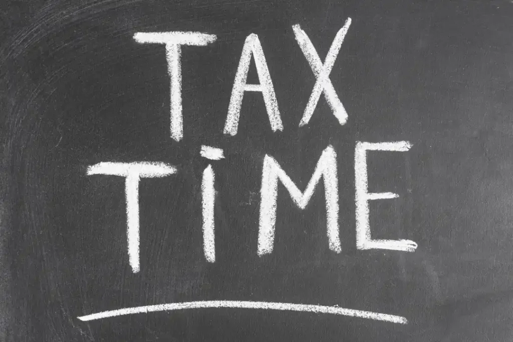 tax time written black backboard with chalk