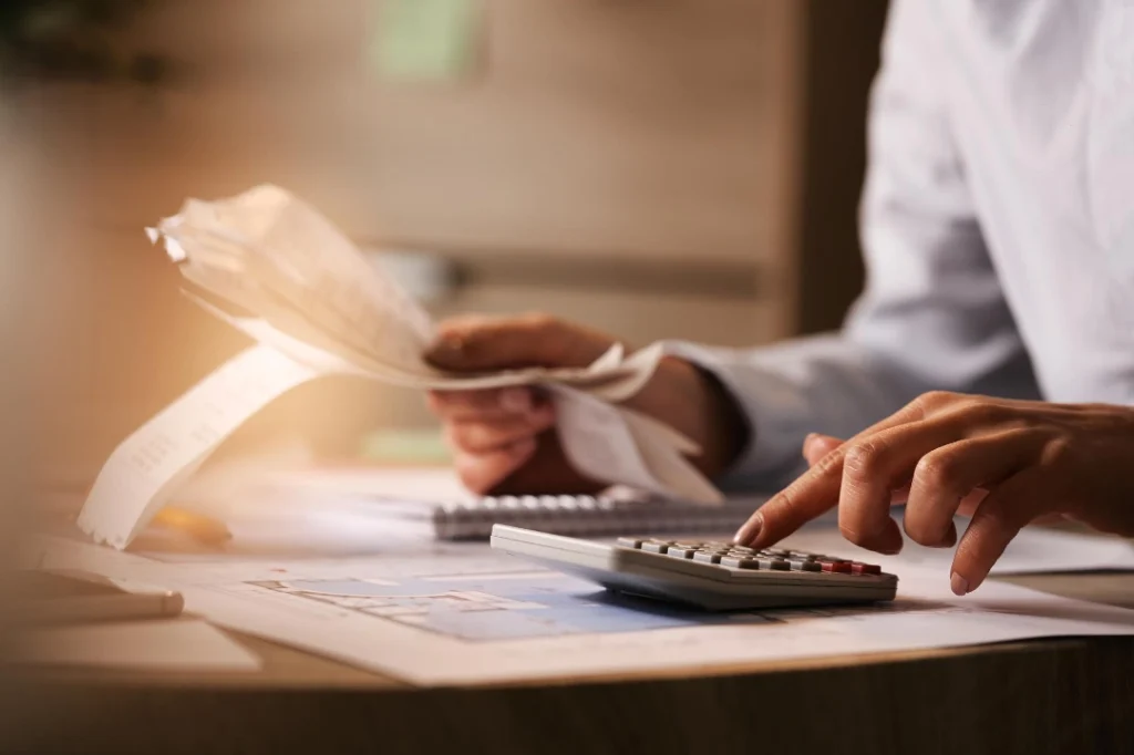 A man budgeting using calculator